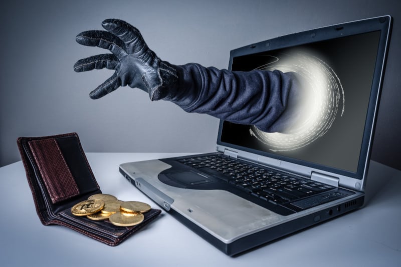 hacker reaching for Bitcoin