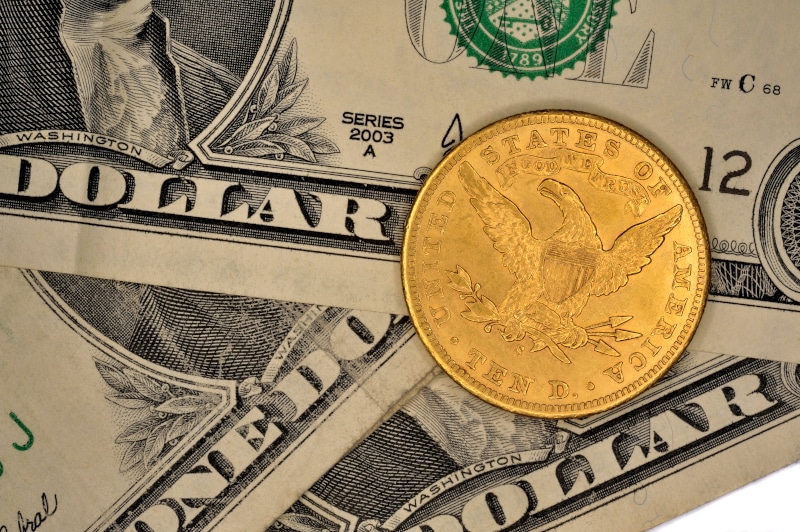 Gold Eagle coin on US dollars